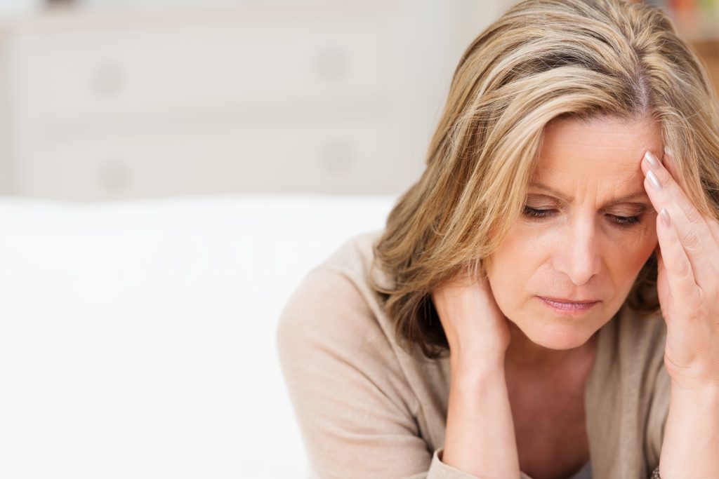 woman holding head, stressed