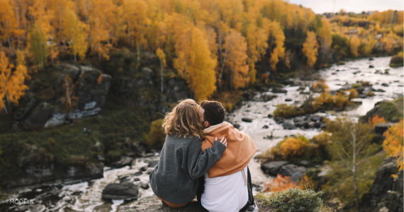 man and woman looking at fall foliage