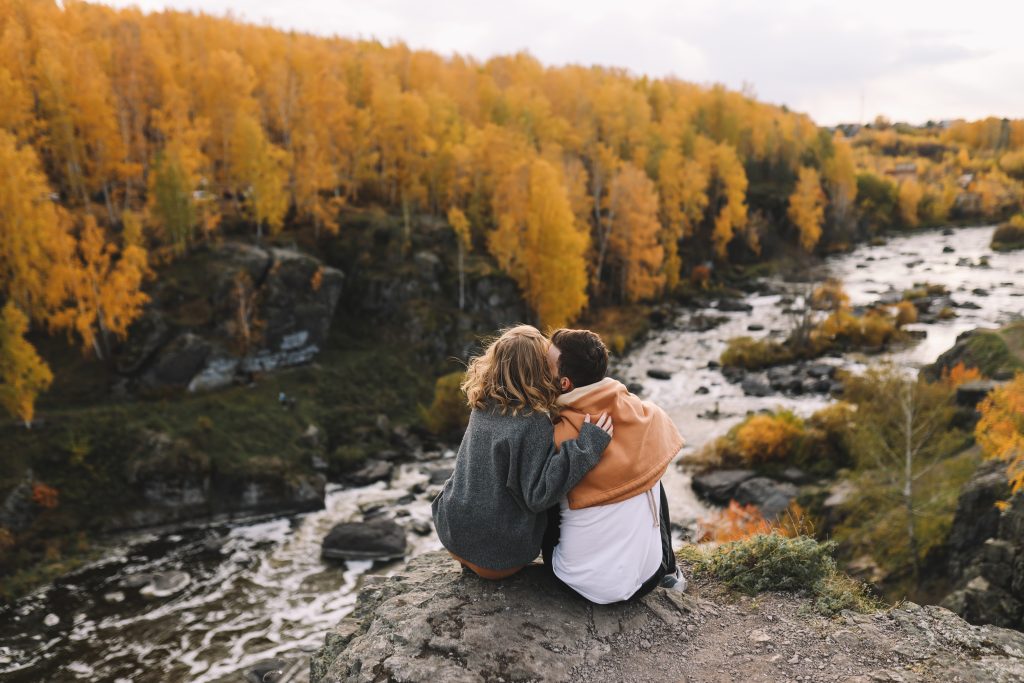 man and woman looking at fall foliage