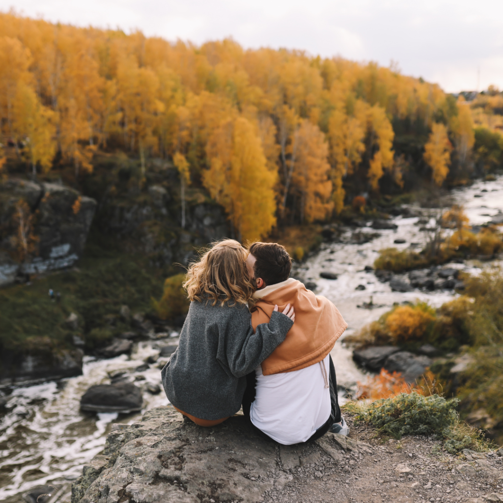 man and woman looking at fall foliage