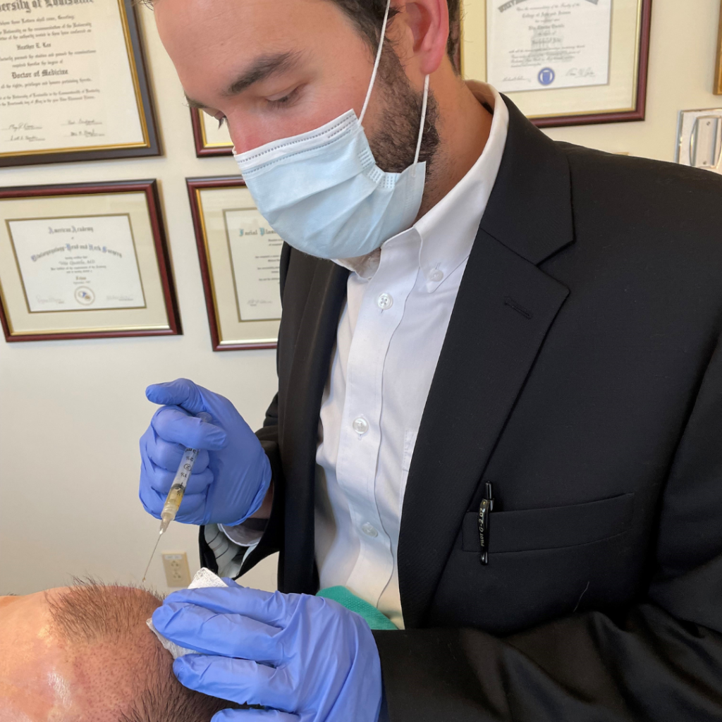Dr. Montague injecting patient scalp with PRP