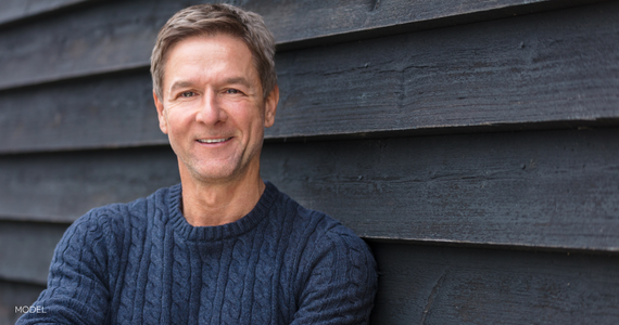 close up of middle aged man smiling, looking into the camera